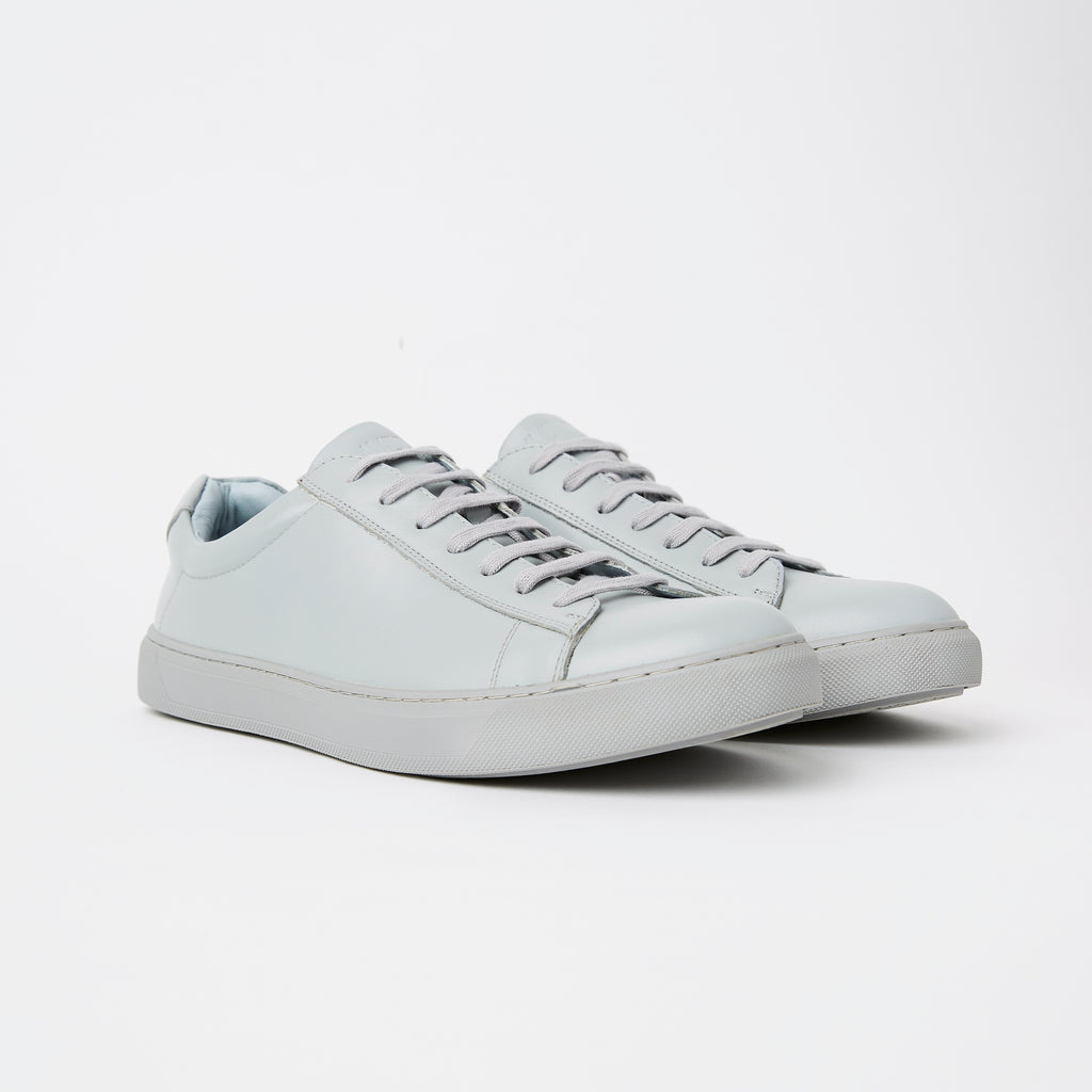 a pair of mens leather sneakers in a light dove grey with colour matched laces